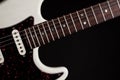 White electric guitar close-up of fingerboard frets and body Royalty Free Stock Photo