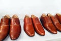 Classic fashion polished men`s brown shoes on white shelf in a store. Selective focus. Sale and shopping concept. Copy space Royalty Free Stock Photo