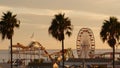Classic ferris wheel, amusement park on pier in Santa Monica pacific ocean beach resort. Summertime California aesthetic, iconic