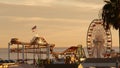 Classic ferris wheel, amusement park on pier in Santa Monica pacific ocean beach resort. Summertime California aesthetic, iconic