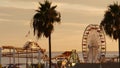 Classic ferris wheel, amusement park on pier in Santa Monica pacific ocean beach resort. Summertime California aesthetic, iconic