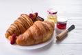 Fresh Croissant with berries and jam for breakfast isolated on white wooden background , copy space Royalty Free Stock Photo