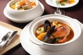 classic french dishes, like bouillabaisse and cassoulet, on a white plate