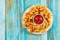 Classic french fries and tasti taters with ketchup on wooden table