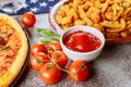 Classic french fries and tasti taters with ketchup on wooden table