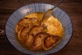 Classic French onion soup baked with cheese croutons sprinkled with fresh thyme, close up view. Royalty Free Stock Photo