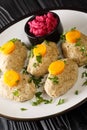Classic Gefilte Fish Gently cooked fish patties in the simmering fish stock closeup in the plate. Vertical