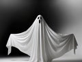 Classic ghost figure in white sheet on black background. Royalty Free Stock Photo