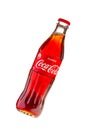 Classic glass bottle of Coca-Cola with a volume of 0.33 liters isolated on a white background shot at an angle. Moscow, August,