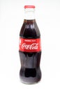 Classic glass bottle of Coca-Cola on white background