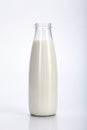 The classic glass bottle with milk on a white background