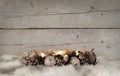 Classic golden Christmas tealight holder with burning candles, on sheepskin