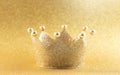 A A Classic Golden Crown on a Glittery Golden Background