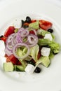 Classic Greek salad of fresh vegetables with feta cheese in a white plate. Delicious Mediterranean food. Vitamins and healthy food Royalty Free Stock Photo