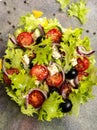 Classic greek salad in a glass deep plate. Top view. Close-up.