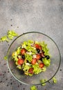 Classic greek salad in a glass deep plate. Top view. Copy space for text.