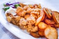 Classic greek taverna plate with fried calamari and baked potatoes, seafood Royalty Free Stock Photo