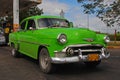 Classic Green yank tank Cuban Chevrolet Car in front of a Gas Station in Cuba