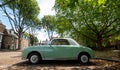 Vintage green Nissan Figaro car parked on a street in Brentford, West London, UK.