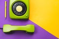 Classic green phone with yellow pen. office background. vintage telephone with phone receiver. old communication technology Royalty Free Stock Photo