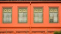 Classic green wood window at the orange concrete building. Royalty Free Stock Photo