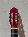 A classic red guitar head make of wood. Royalty Free Stock Photo