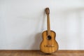 classic guitar lying in front of a wall as background Royalty Free Stock Photo