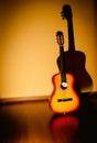 Classic guitar standing near to a wall and a blurry background Royalty Free Stock Photo