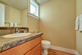 Classic half bathroom interior with vanity cabinet and a toilet.