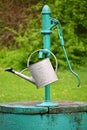 Classic hand pump for water - well with kettle for watering the garden Royalty Free Stock Photo