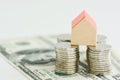 Classic home model with pile of coins isolated Royalty Free Stock Photo