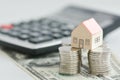 Classic home model with pile of coins isolated Royalty Free Stock Photo