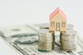 Classic home model with pile of coins isolated Royalty Free Stock Photo