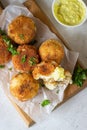 Classic homemade Italian arancini. Fried rice balls with minced meat served with parsley and cheese sauce. Top view
