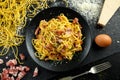Classic Homemade Pasta carbonara Italian with Bacon, eggs, Parmesan Cheese on black plate. Royalty Free Stock Photo