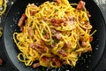 Classic Homemade Pasta carbonara Italian with Bacon, eggs, Parmesan Cheese on black plate. Royalty Free Stock Photo