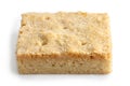 Classic homemade square shortbread biscuit isolated on white.