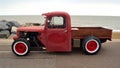 Classic Hot Rod pickup truck on seafront promenade with sea in background Royalty Free Stock Photo