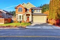 Classic house with garage, driveway, and grassy front yard. Royalty Free Stock Photo