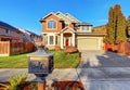 Classic house with garage, driveway, and grassy front yard. Royalty Free Stock Photo