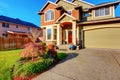 Classic house with garage, driveway, and grassy front yard. Royalty Free Stock Photo