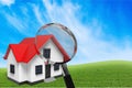 Classic house model with magnify glass on Royalty Free Stock Photo