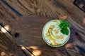 Classic hummus appetizer of chickpeas, tahini, olive oil, and oriental spices in a bowl on a wooden table. Traditional Royalty Free Stock Photo