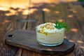 Classic hummus appetizer of chickpeas, tahini, olive oil, and oriental spices in a bowl on a wooden table. Traditional Royalty Free Stock Photo