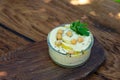 Classic hummus appetizer of chickpeas, tahini, olive oil, and oriental spices in a bowl on a wooden table. Traditional Royalty Free Stock Photo