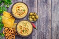 Classic hummus in bowls on wooden table. With copy space. Top view