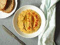 Classic hummus with hot pepper on a white plate. National, vegetarian dish