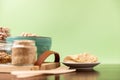 Classic hummus on a small plate on wooden table. Green Background.