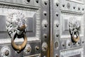 Classic iron gate with handles in the form of lion heads in the center of St. Petersburg, Russia.