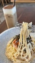 Classic Italian food creamy spaghetti with crab willow, seaweed and iced coffee in the cafe